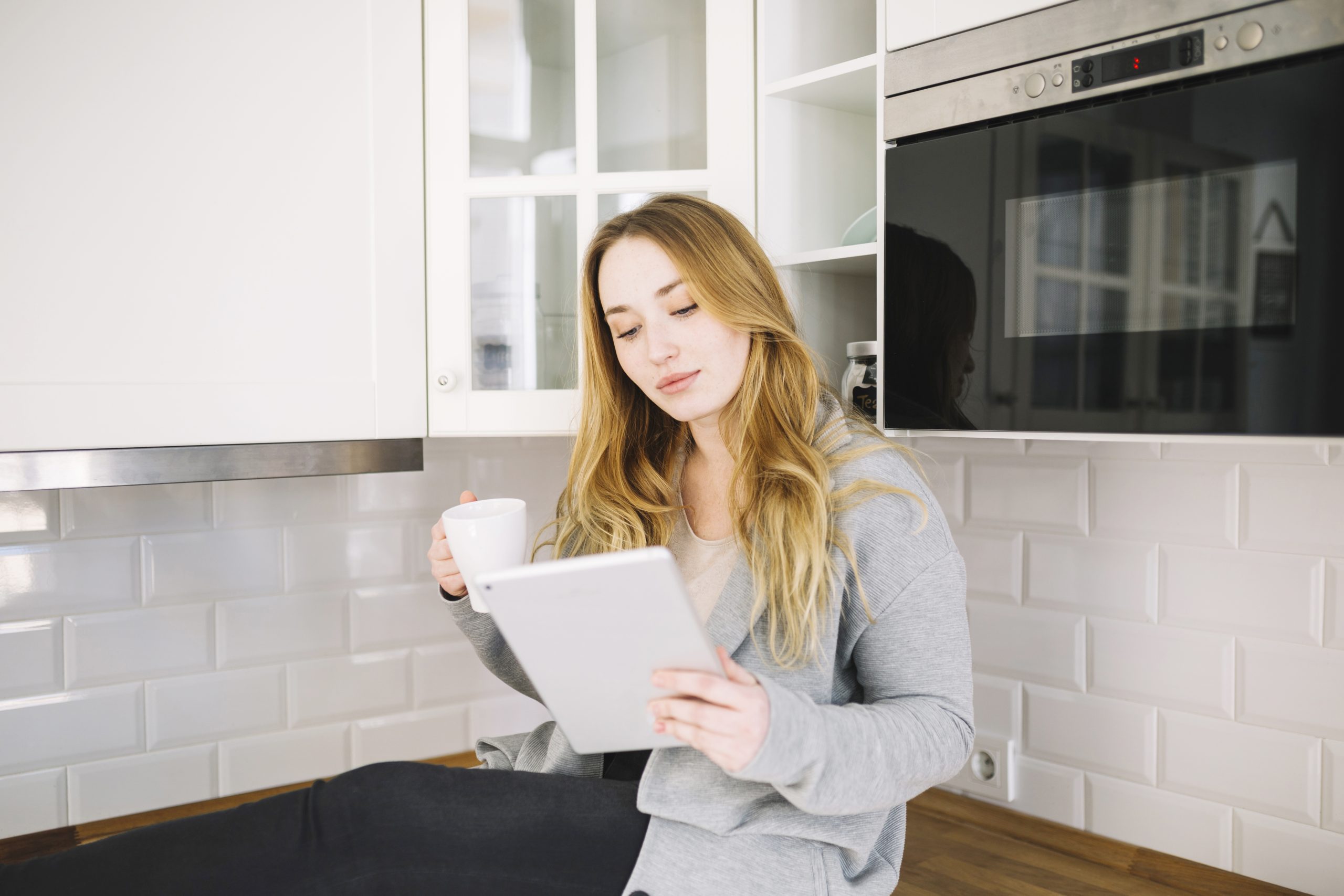 A homeowner reviewing documents at a kitchen island